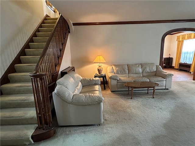 174 N Bennett St, Bradford-City, PA 16701 - carpeted living area featuring arched walkways, stairs, and crown molding