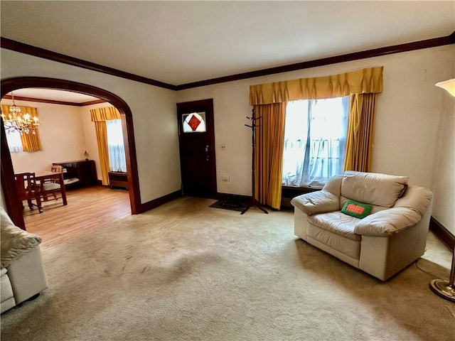 174 N Bennett St, Bradford-City, PA 16701 - living area featuring arched walkways, a chandelier, plenty of natural light, light colored carpet, and crown molding