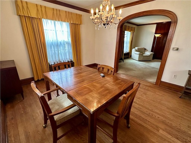 174 N Bennett St, Bradford-City, PA 16701 - dining space featuring arched walkways, ornamental molding, wood finished floors, and baseboards