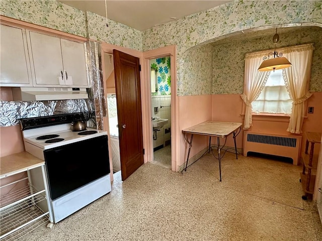 174 N Bennett St, Bradford-City, PA 16701 - kitchen featuring white range with electric cooktop, radiator heating unit, wallpapered walls, under cabinet range hood, and a wainscoted wall