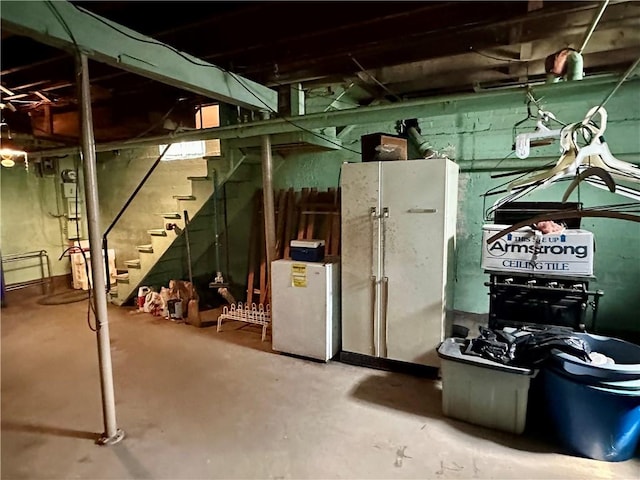 174 N Bennett St, Bradford-City, PA 16701 - unfinished basement featuring stairway and freestanding refrigerator