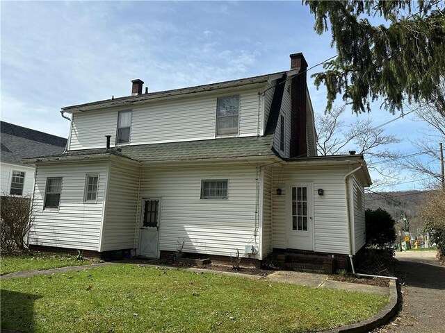 174 N Bennett St, Bradford-City, PA 16701 - rear view of property featuring a chimney, entry steps, a yard, and a shingled roof
