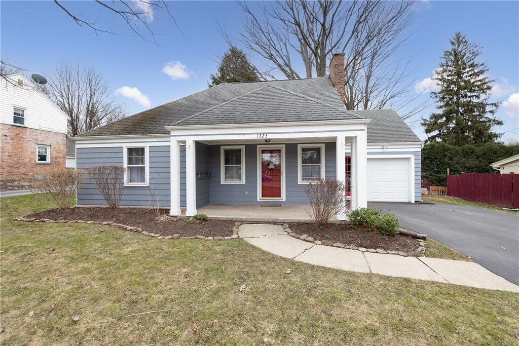1323 Howard Rd, Gates, NY 14624 - view of front of property featuring an attached garage, aphalt driveway, covered porch, a shingled roof, and a chimney