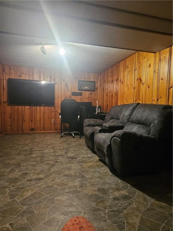 305 State St, Smethport-Borough, PA 16749 - living room with lofted ceiling with beams, stone floors, and wood walls