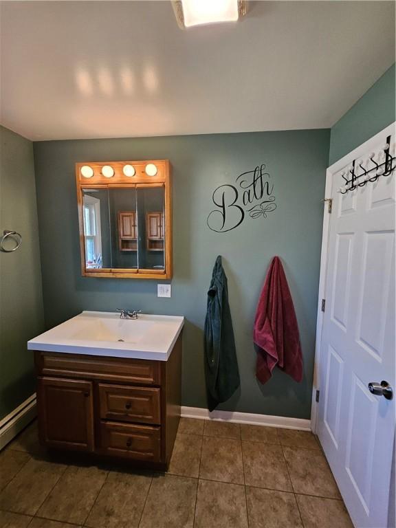 305 State St, Smethport-Borough, PA 16749 - bathroom with tile patterned floors, vanity, baseboards, and baseboard heating