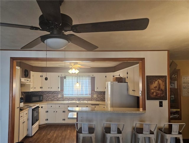 305 State St, Smethport-Borough, PA 16749 - kitchen featuring under cabinet range hood, white cabinets, a sink, and white appliances