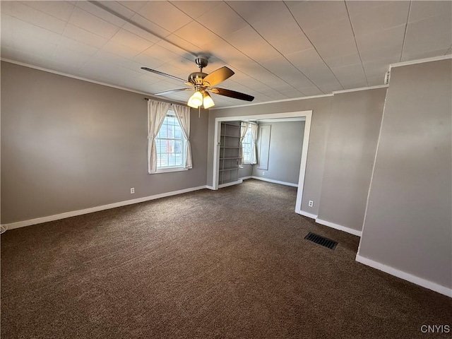 318 Academy St, Watertown-City, NY 13601 - unfurnished room with crown molding, ceiling fan, baseboards, and dark colored carpet