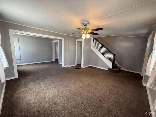 318 Academy St, Watertown-City, NY 13601 - unfurnished living room with dark colored carpet, ceiling fan, stairway, baseboards, and ornamental molding
