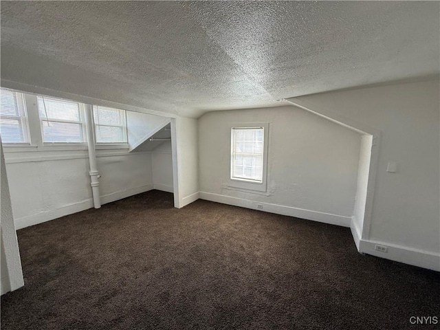 318 Academy St, Watertown-City, NY 13601 - below grade area featuring a textured ceiling, dark colored carpet, and baseboards
