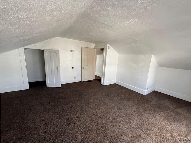 318 Academy St, Watertown-City, NY 13601 - bonus room with lofted ceiling, dark carpet, a textured ceiling, and baseboards
