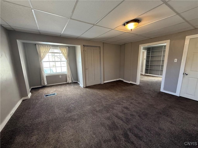 318 Academy St, Watertown-City, NY 13601 - unfurnished room featuring dark colored carpet, a paneled ceiling, and baseboards
