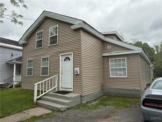 318 Academy St, Watertown-City, NY 13601 - view of front facade with a front yard