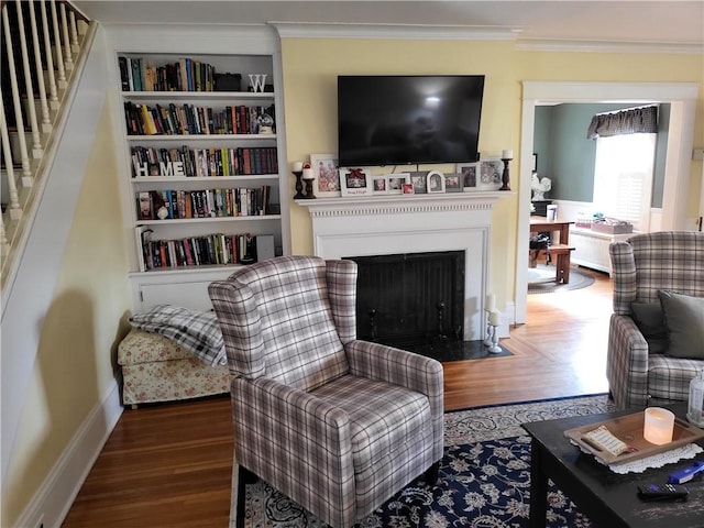 114 Country Club Dr, Elmira, NY 14905 - sitting room with a fireplace with flush hearth, wood finished floors, built in features, and ornamental molding