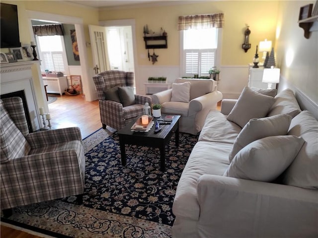 114 Country Club Dr, Elmira, NY 14905 - living area with wainscoting, wood finished floors, a fireplace, and a healthy amount of sunlight
