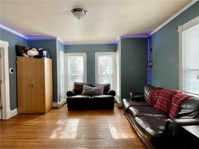 living area with wood finished floors and crown molding