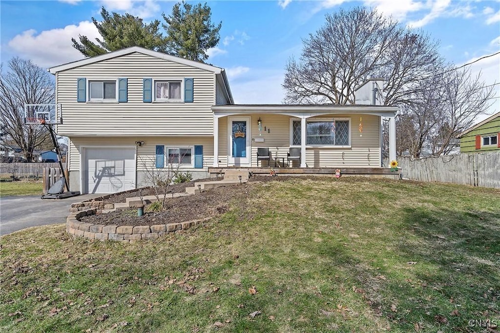 11 Dove, Clay, NY 13090 - split level home with driveway, a front yard, covered porch, fence, and a garage