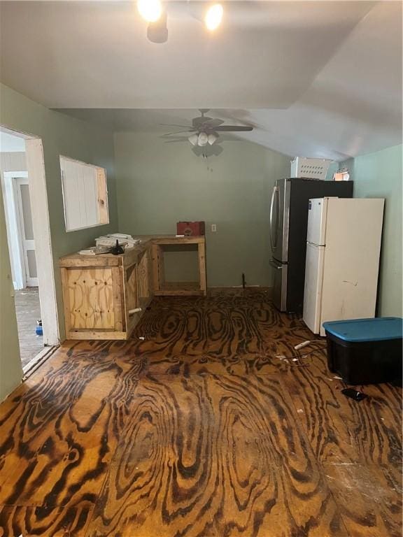 kitchen featuring lofted ceiling, ceiling fan, white cabinets, and freestanding refrigerator