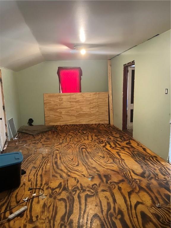 additional living space featuring vaulted ceiling