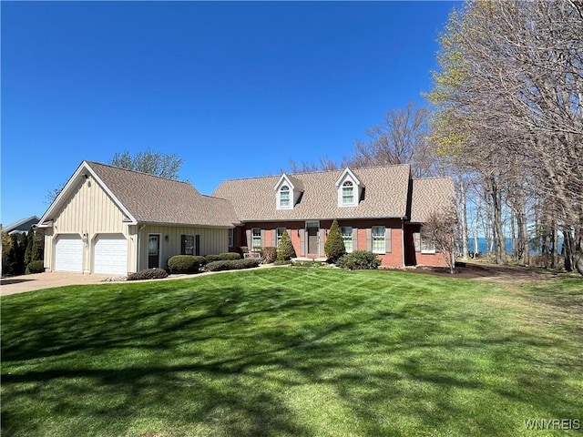 7131 Lakeshore Ter, Newfane, NY 14008 - cape cod home with concrete driveway, a front yard, a garage, and board and batten siding
