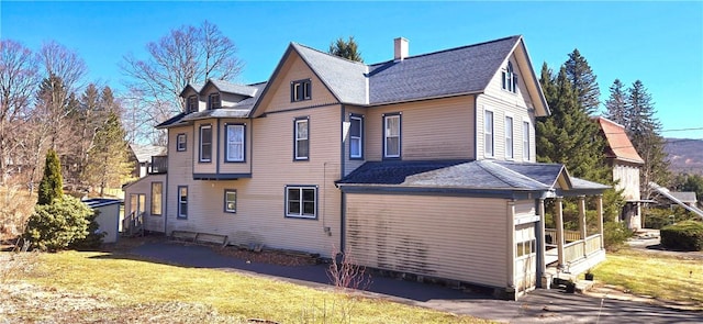back of property with a sunroom, central air condition unit, and a yard