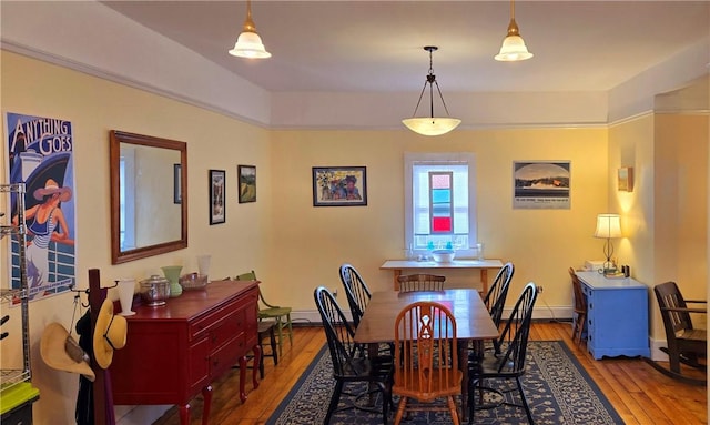 dining room featuring baseboards and hardwood / wood-style flooring