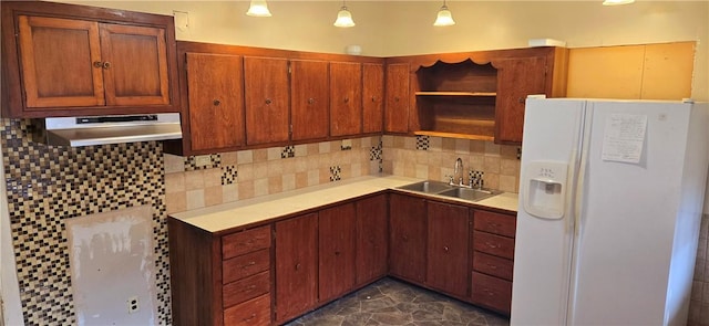 kitchen featuring tasteful backsplash, open shelves, under cabinet range hood, a sink, and white fridge with ice dispenser