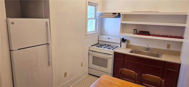 kitchen featuring light countertops, a sink, open shelves, under cabinet range hood, and white appliances