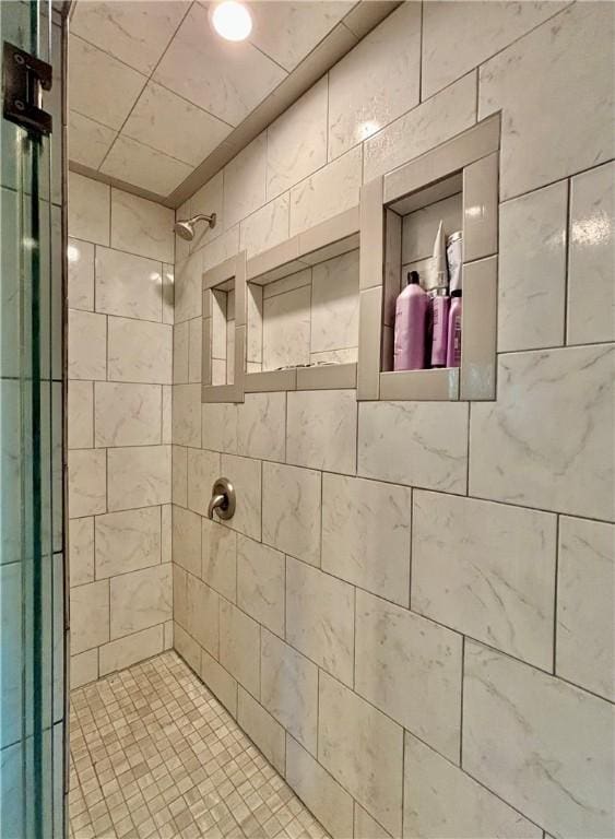 bathroom with a tile shower