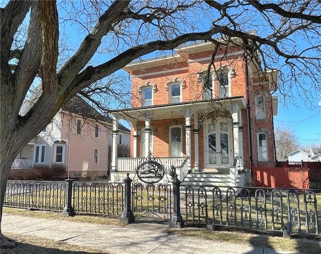 280 S Main St, Canandaigua-City, NY 14424 - italianate house featuring brick siding, a porch, and a fenced front yard