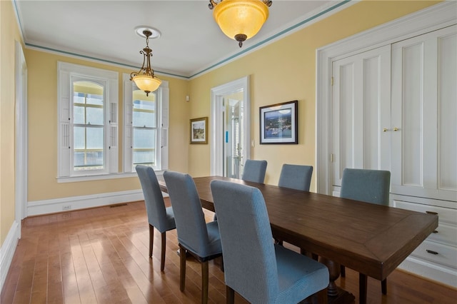 280 S Main St, Canandaigua-City, NY 14424 - dining area with baseboards, visible vents, wood finished floors, and ornamental molding