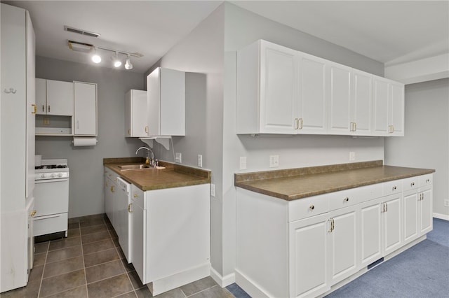 280 S Main St, Canandaigua-City, NY 14424 - kitchen featuring white cabinets, dark tile patterned floors, white appliances, dark countertops, and a sink