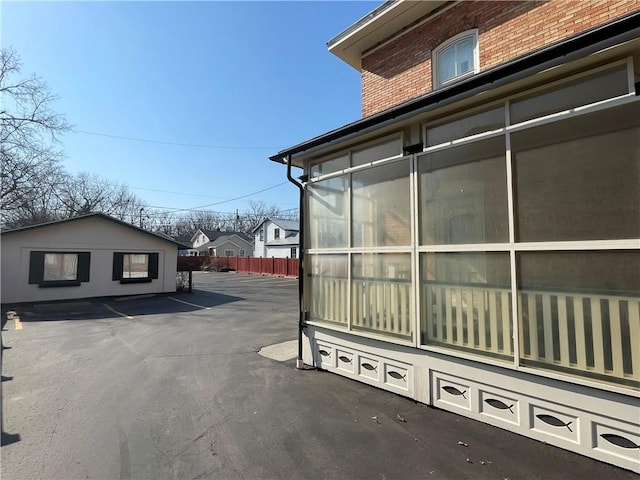 280 S Main St, Canandaigua-City, NY 14424 - view of side of property featuring a sunroom and fence