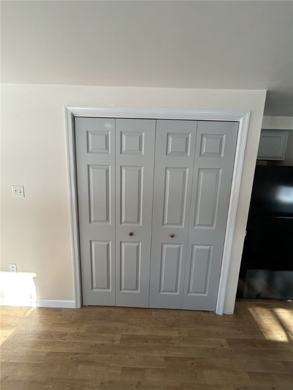 room details featuring baseboards and wood finished floors