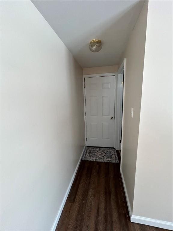 hallway with baseboards and wood finished floors