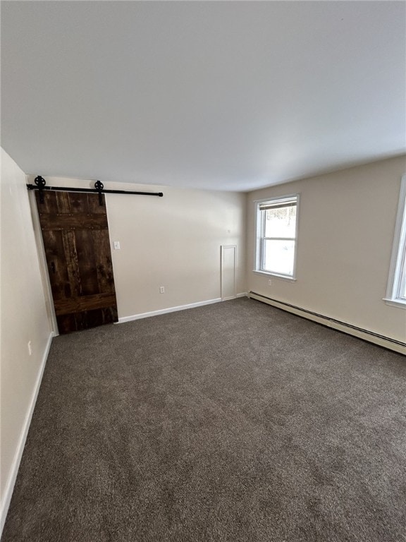 unfurnished room featuring baseboards, dark colored carpet, and a baseboard heating unit