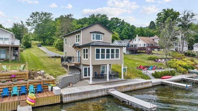 2310 Olanco Rd, Spafford, NY 13110 - rear view of property with a deck with water view, a standing seam roof, metal roof, a yard, and a patio