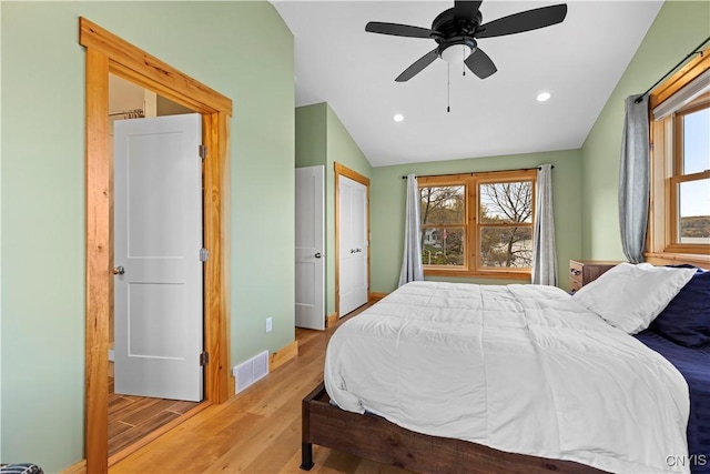 2310 Olanco Rd, Spafford, NY 13110 - bedroom with wood finished floors, multiple windows, vaulted ceiling, baseboards, and recessed lighting