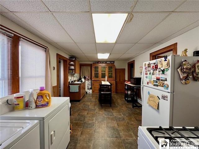 546 S Roberts Rd, Dunkirk-City, NY 14048 - kitchen with light countertops, gas stove, a paneled ceiling, washer and clothes dryer, and freestanding refrigerator