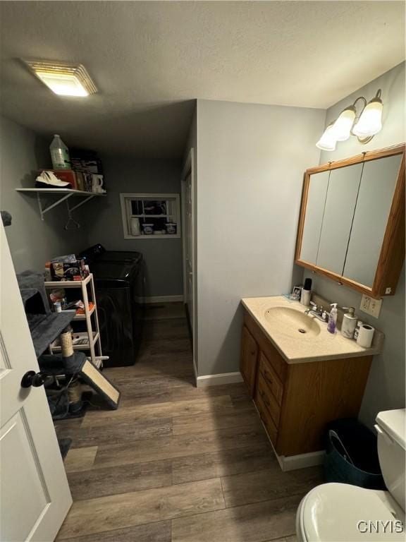 439 S Mechanic St, Wilna, NY 13619 - bathroom featuring independent washer and dryer, vanity, wood finished floors, toilet, and baseboards