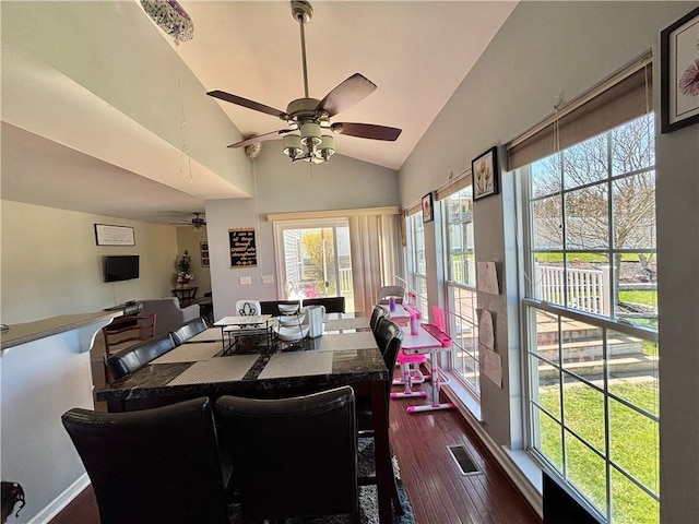 dining space with lofted ceiling, dark wood-style floors, visible vents, and a ceiling fan