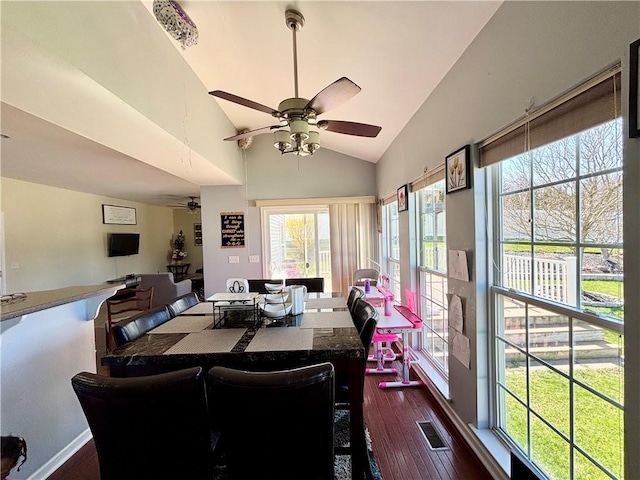 dining area featuring a ceiling fan, dark wood-style floors, lofted ceiling, and visible vents