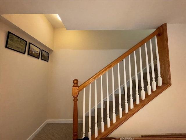 stairway featuring carpet flooring and baseboards