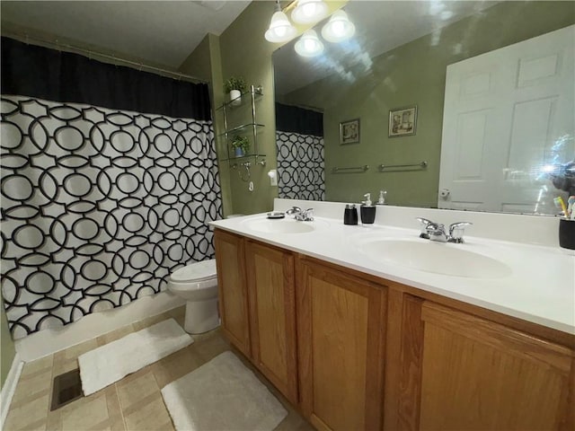 bathroom with a shower with curtain, toilet, a sink, and double vanity