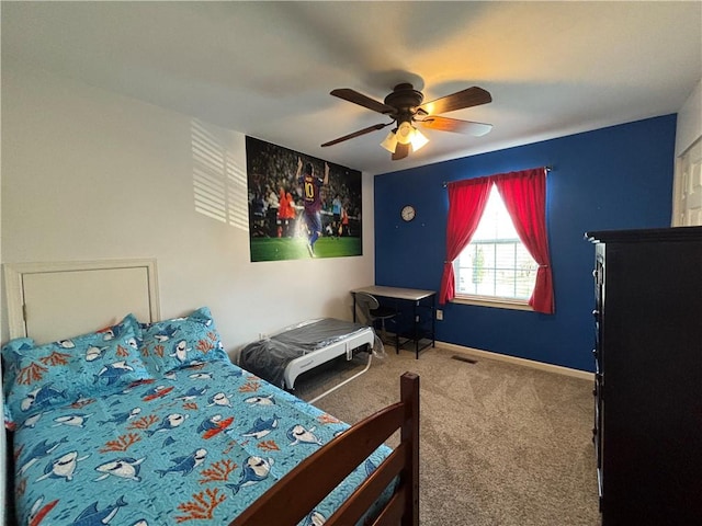 carpeted bedroom featuring baseboards, ceiling fan, and visible vents