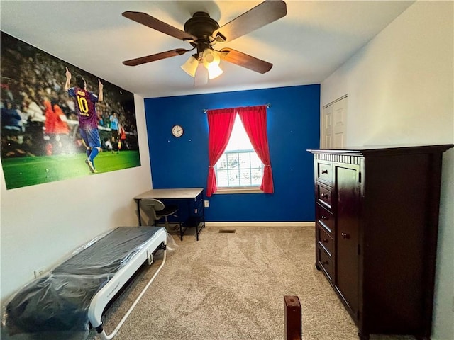 bedroom with a ceiling fan, carpet floors, and baseboards