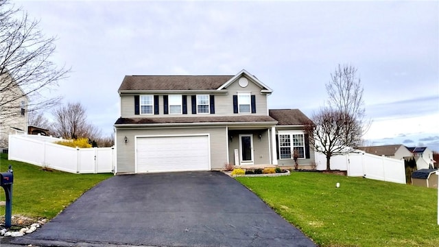 traditional home featuring aphalt driveway, a gate, fence, an attached garage, and a front lawn