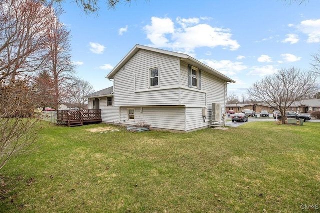 rear view of property featuring a yard and a deck