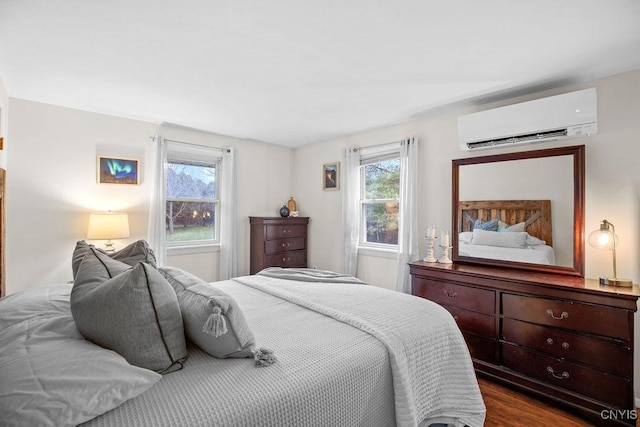 bedroom with an AC wall unit and dark wood-type flooring