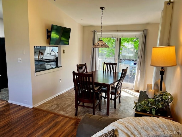 dining space with wood finished floors and baseboards