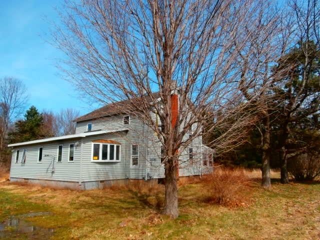 view of property exterior featuring a lawn